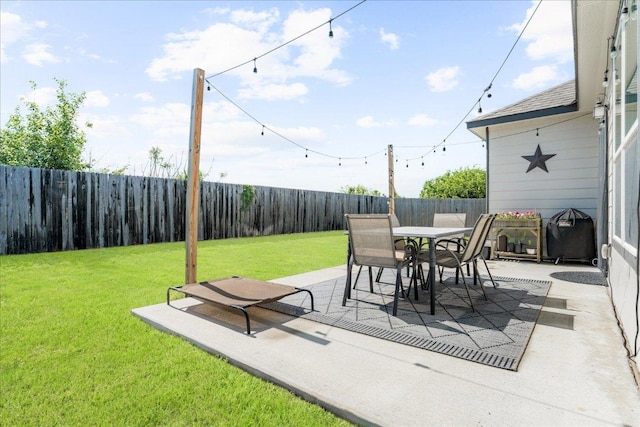 view of patio with outdoor dining area and a fenced backyard