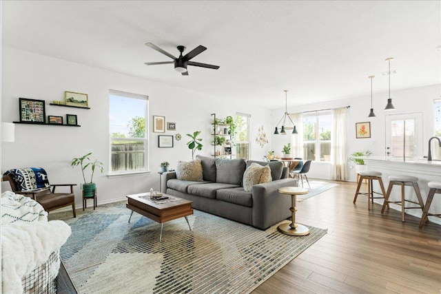 living area with ceiling fan and wood finished floors
