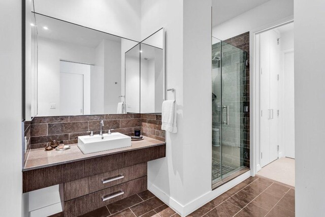 210 Lavaca St Unit 2308, Austin, TX 78701 - full bathroom with a shower stall, vanity, and decorative backsplash