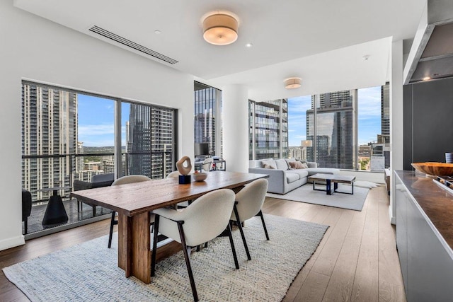 210 Lavaca St Unit 2308, Austin, TX 78701 - dining space featuring a healthy amount of sunlight, hardwood / wood-style flooring, and a view of city