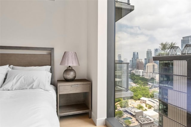 44 E Ave Unit 2907, Austin, TX 78701 - bedroom featuring baseboards and a view of city