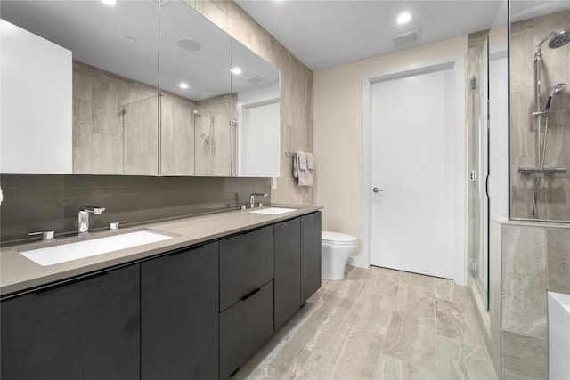 44 E Ave Unit 2907, Austin, TX 78701 - full bath featuring double vanity, toilet, a stall shower, and a sink
