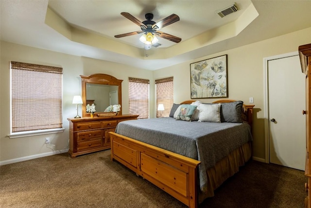511 Shadywood Ln, Dripping Springs, TX 78620 - bedroom with a raised ceiling, dark carpet, baseboards, and a ceiling fan