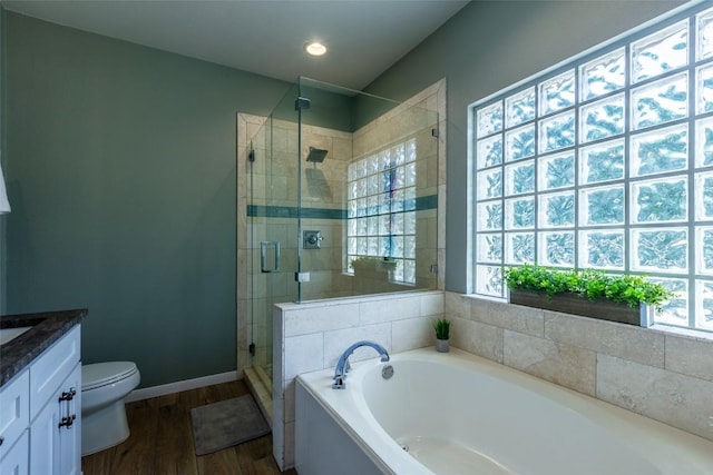 511 Shadywood Ln, Dripping Springs, TX 78620 - full bath featuring a garden tub, vanity, toilet, a shower stall, and wood finished floors