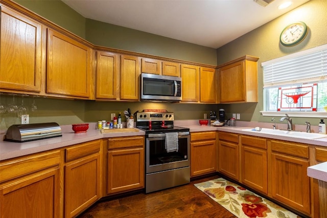 511 Shadywood Ln, Dripping Springs, TX 78620 - kitchen with appliances with stainless steel finishes, a sink, light countertops, and dark wood-type flooring