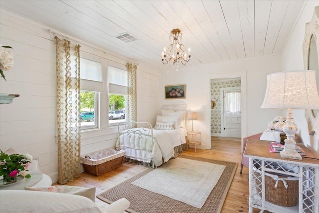 bedroom with wooden ceiling, visible vents, wood finished floors, and a notable chandelier