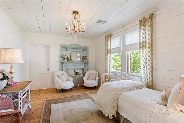bedroom with wooden ceiling, visible vents, wood finished floors, and a notable chandelier