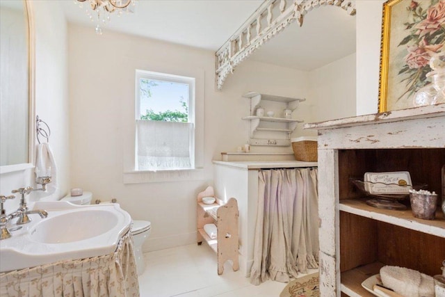 half bath with vanity, toilet, and baseboards
