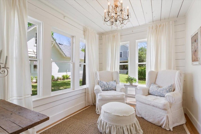 living area featuring a chandelier, wood ceiling, and baseboards