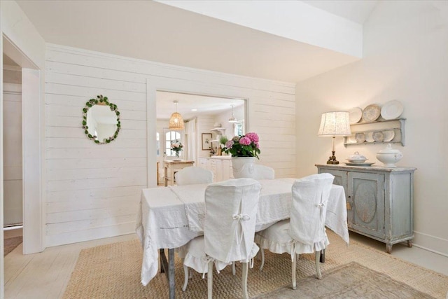 dining space featuring wooden walls