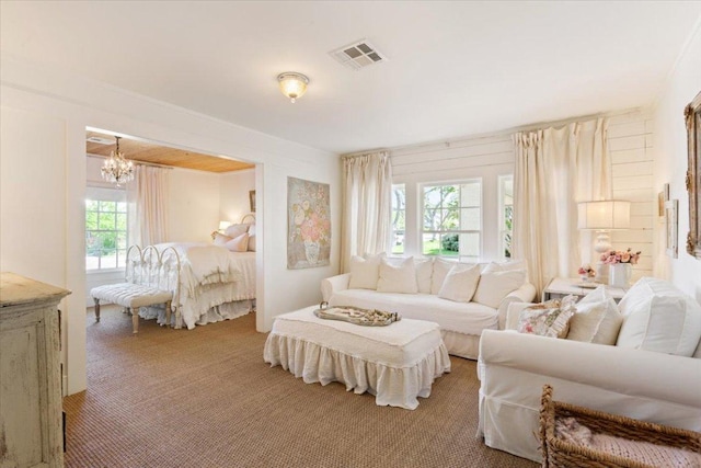 interior space featuring light carpet, a chandelier, and visible vents