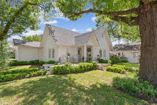 rear view of property featuring a yard