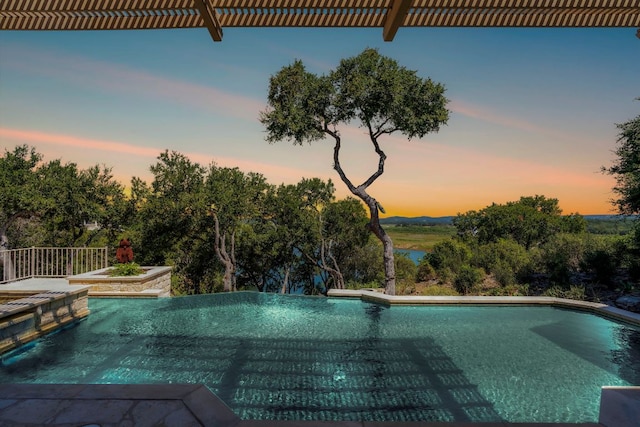 26302 Countryside Dr, Spicewood, TX 78669 - pool at dusk featuring a jacuzzi and an outdoor pool