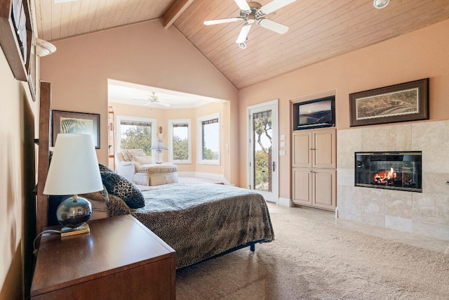bedroom featuring access to outside, a tiled fireplace, ceiling fan, and wooden ceiling
