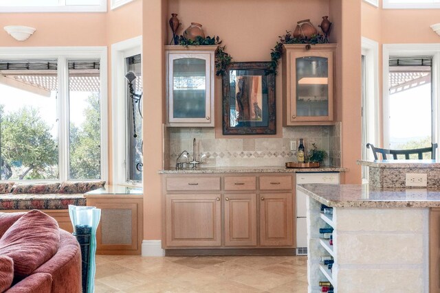 26302 Countryside Dr, Spicewood, TX 78669 - indoor wet bar with tasteful backsplash, light tile patterned floors, and dishwasher