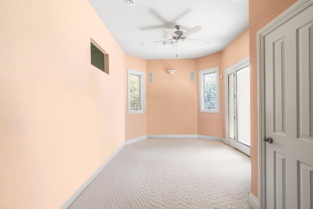 26302 Countryside Dr, Spicewood, TX 78669 - unfurnished room with light carpet, baseboards, and a ceiling fan