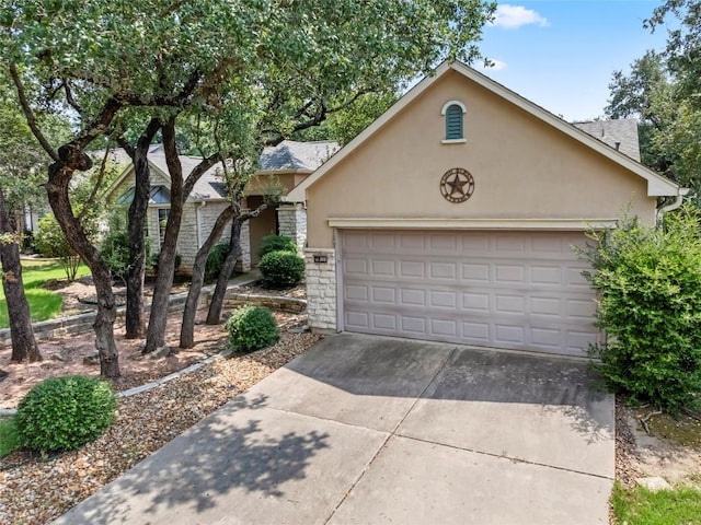 105 Saddle Trl, Georgetown, TX 78633 - view of front facade with driveway, stucco siding, a garage, and stone siding
