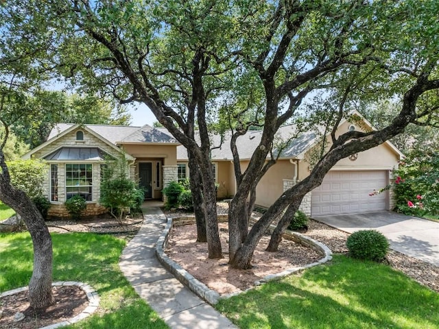 105 Saddle Trl, Georgetown, TX 78633 - view of front of house with driveway, a garage, stucco siding, stone siding, and a front lawn