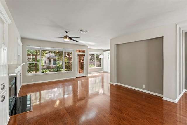 105 Saddle Trl, Georgetown, TX 78633 - unfurnished living room with wood finished floors, baseboards, and ceiling fan