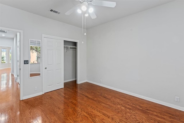 105 Saddle Trl, Georgetown, TX 78633 - unfurnished bedroom with a closet, wood finished floors, visible vents, a ceiling fan, and baseboards