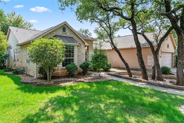 105 Saddle Trl, Georgetown, TX 78633 - view of front of home with stone siding, a shingled roof, a garage, and a front lawn