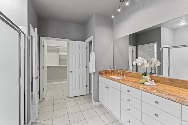 105 Saddle Trl, Georgetown, TX 78633 - full bathroom featuring visible vents, a shower stall, tile patterned floors, vanity, and a walk in closet