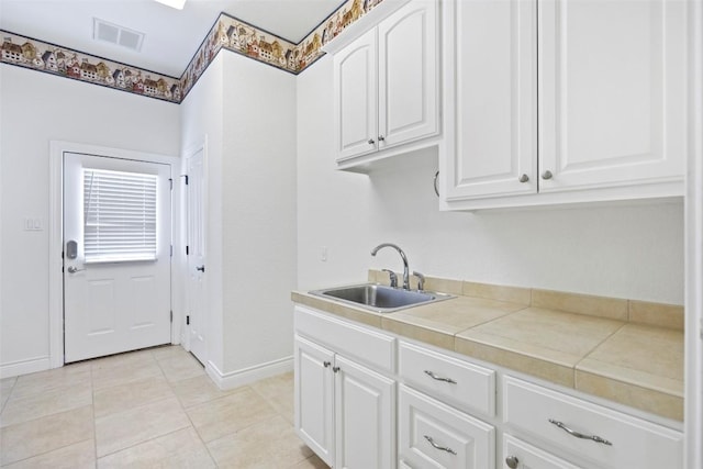 110 Woodall Dr, Georgetown, TX 78628 - kitchen featuring white cabinets, tile counters, and light tile patterned floors