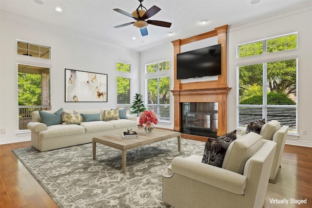110 Woodall Dr, Georgetown, TX 78628 - living area with a fireplace, crown molding, a ceiling fan, and wood finished floors