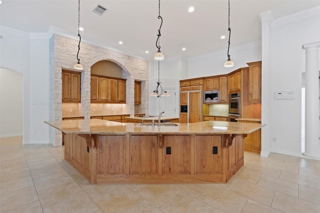110 Woodall Dr, Georgetown, TX 78628 - kitchen with built in appliances, tasteful backsplash, arched walkways, brown cabinetry, and crown molding