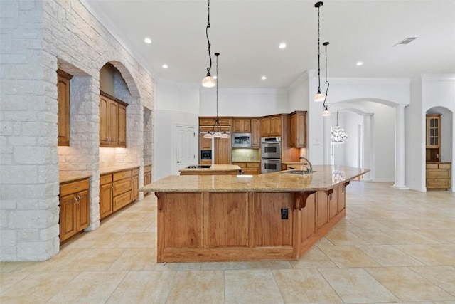 110 Woodall Dr, Georgetown, TX 78628 - kitchen with stainless steel appliances, ornamental molding, a spacious island, backsplash, and arched walkways