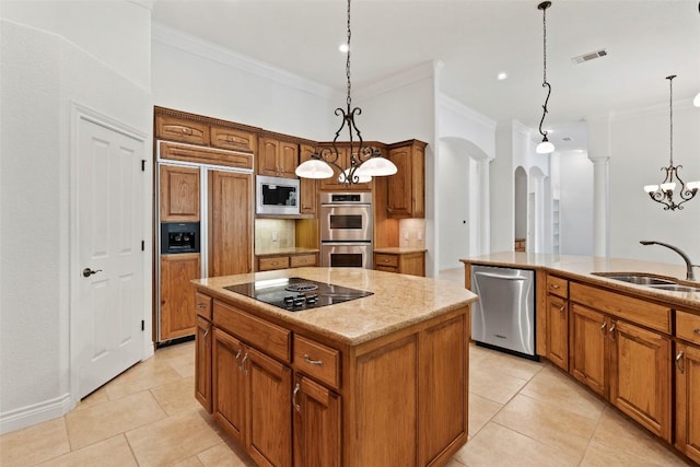 110 Woodall Dr, Georgetown, TX 78628 - kitchen featuring built in appliances, a center island, a sink, crown molding, and arched walkways