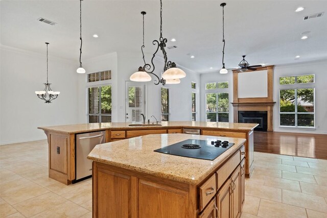 110 Woodall Dr, Georgetown, TX 78628 - kitchen featuring black electric stovetop, a center island with sink, visible vents, and stainless steel dishwasher