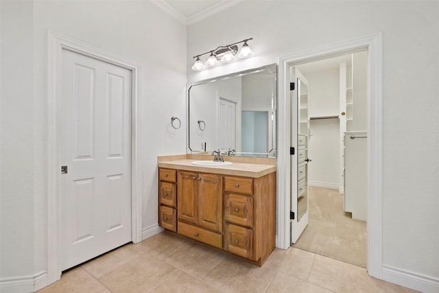 110 Woodall Dr, Georgetown, TX 78628 - bathroom with tile patterned floors, crown molding, baseboards, vanity, and a spacious closet