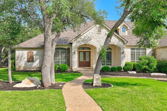 110 Woodall Dr, Georgetown, TX 78628 - view of front of home featuring french doors, stone siding, and a front yard