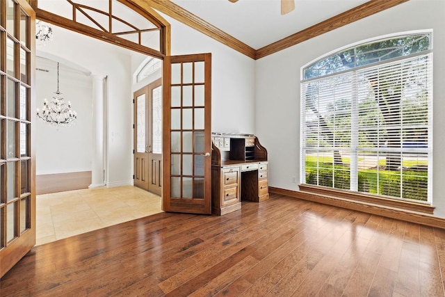 110 Woodall Dr, Georgetown, TX 78628 - unfurnished office with french doors, plenty of natural light, a chandelier, crown molding, and wood finished floors