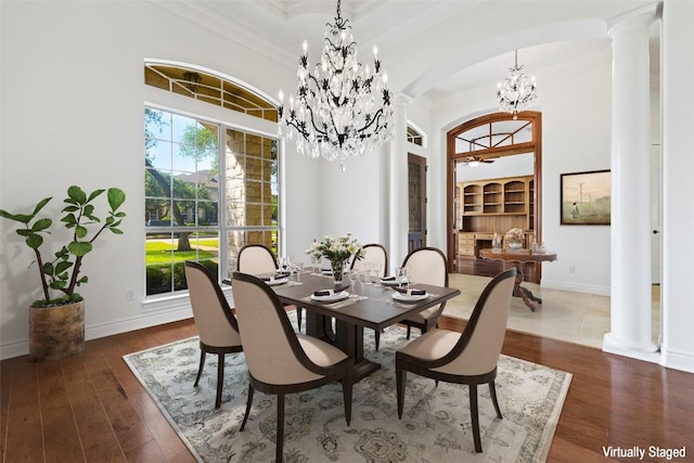 110 Woodall Dr, Georgetown, TX 78628 - dining area featuring a chandelier, ornate columns, arched walkways, ornamental molding, and hardwood / wood-style flooring