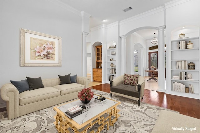 110 Woodall Dr, Georgetown, TX 78628 - living area with wood-type flooring, ornate columns, visible vents, arched walkways, and built in shelves