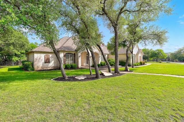110 Woodall Dr, Georgetown, TX 78628 - view of front facade with a front lawn and a shingled roof