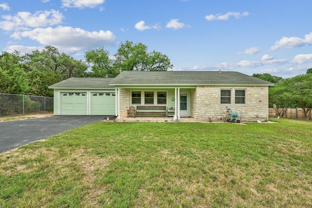 single story home with stone siding, aphalt driveway, an attached garage, and fence