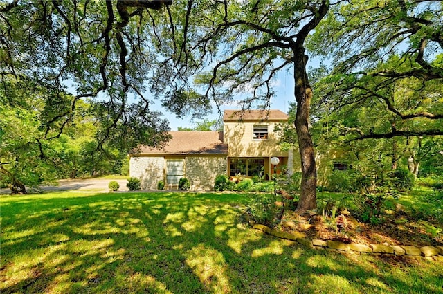 back of house with a yard