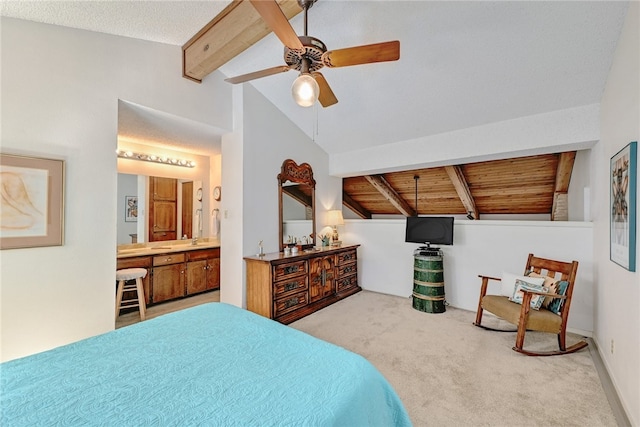 bedroom featuring a ceiling fan, carpet, wooden ceiling, connected bathroom, and vaulted ceiling with beams