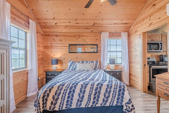 770 Stanton Rd, Johnson City, TX 78636 - bedroom featuring vaulted ceiling, multiple windows, wood ceiling, wooden walls, and light wood-style floors