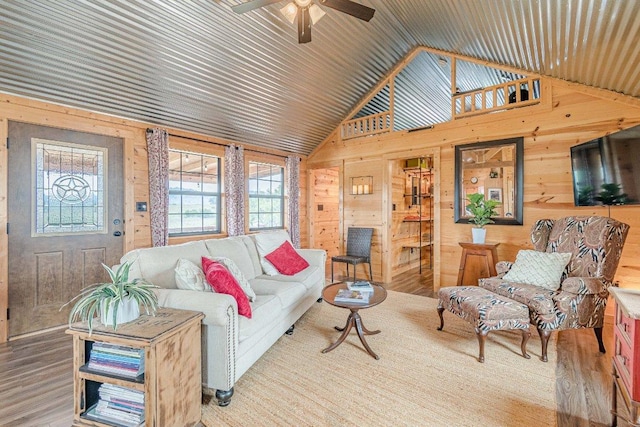 770 Stanton Rd, Johnson City, TX 78636 - living area with lofted ceiling, wood walls, wood finished floors, and a ceiling fan