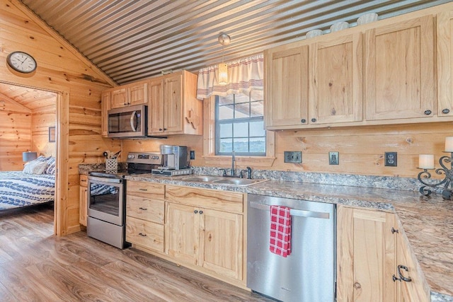 770 Stanton Rd, Johnson City, TX 78636 - kitchen with stainless steel appliances, a sink, light brown cabinets, lofted ceiling, and light wood-type flooring