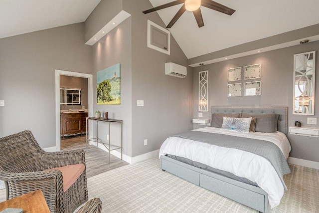 770 Stanton Rd, Johnson City, TX 78636 - bedroom with high vaulted ceiling, baseboards, a wall mounted AC, ensuite bath, and wood finished floors