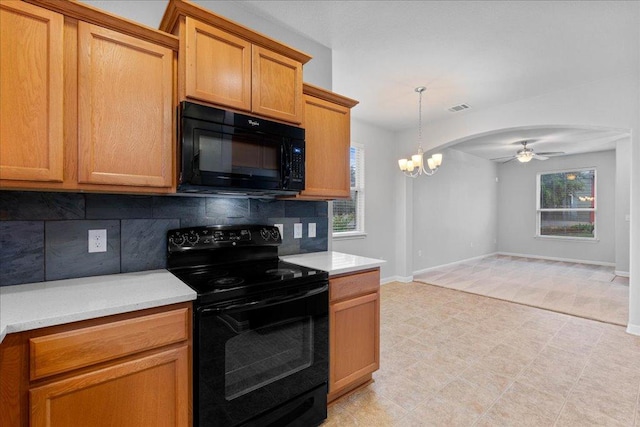 kitchen featuring black appliances, a chandelier, backsplash, ceiling fan, and light countertops