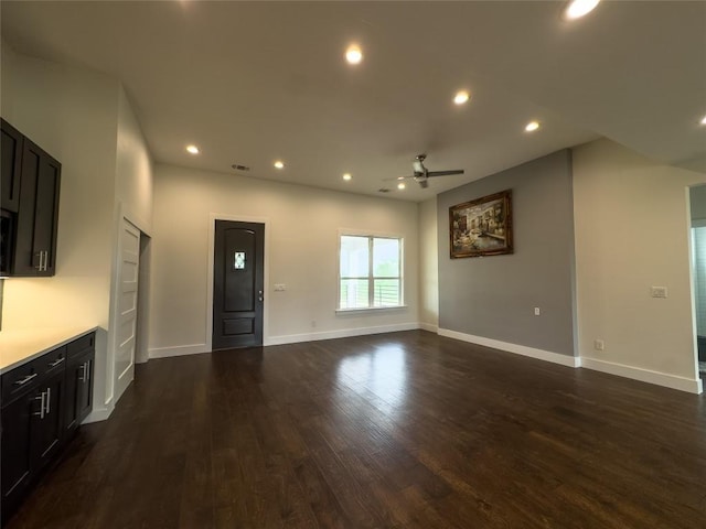 unfurnished living room featuring baseboards, dark wood-style flooring, recessed lighting, and ceiling fan