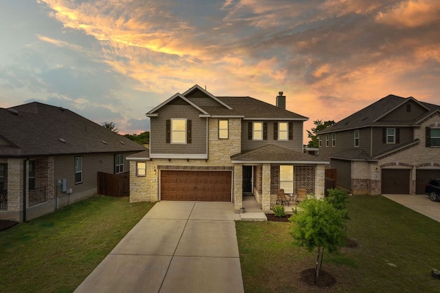 130 Mcginnis Trl, Kyle, TX 78640 - view of front facade with an attached garage, stone siding, a chimney, concrete driveway, and a front lawn