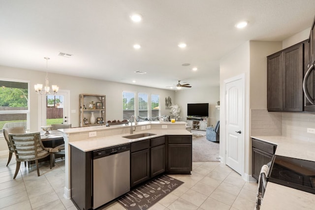 130 Mcginnis Trl, Kyle, TX 78640 - kitchen featuring dark brown cabinets, light countertops, stainless steel appliances, and a sink