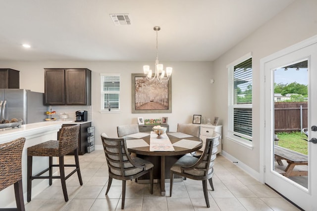 130 Mcginnis Trl, Kyle, TX 78640 - dining space featuring light tile patterned floors, a notable chandelier, visible vents, and baseboards